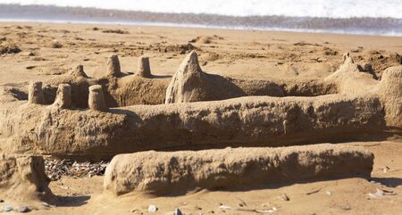 Sand castle on the beach. The sand palace was built by children on sea coast
