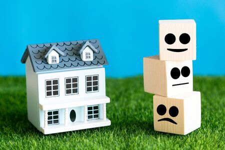 Assessment of the quality of the house in the form of emotions. A symbolic assessment of the quality of hotel services. Emotions from positive to negative. Conceptual photo.の写真素材