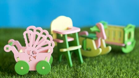 Children's furniture, crib, high chair, stroller on the green grass.
の写真素材