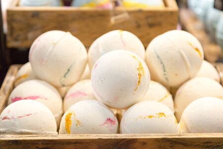 Colored bath bombs on a store counter. Bright multi-colored bath bombs in a basket.,の写真素材