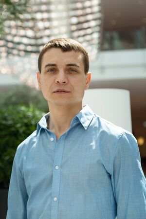A 30-35 year old man in a blue shirt. Portrait of an adult Caucasian man with a blue shirt.の写真素材