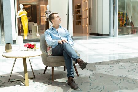 A man is waiting in a cafe waiting for his girlfriend for a date Stylish young man is waiting for a...