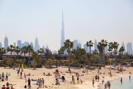 La Mer is the new beach area of Dubai, a city beach with a unique atmosphere of modern comfort. Wide boulevards, palm trees, graffiti, cafes and restaurants. Vacationers by the seaの写真素材