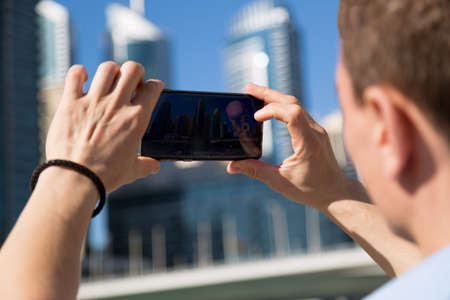 A man photographs local attractions of the country.