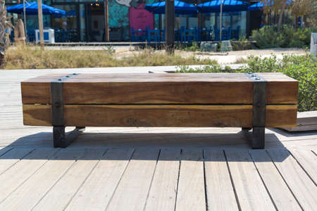 Vintage bench made of large thick logs.