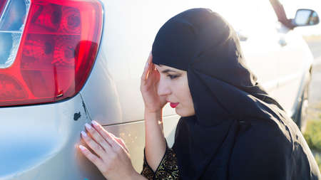Woman damaged the bumper of her car.の写真素材