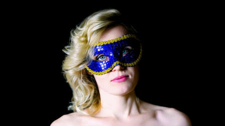 Woman in blue eye mask with bare shoulders.