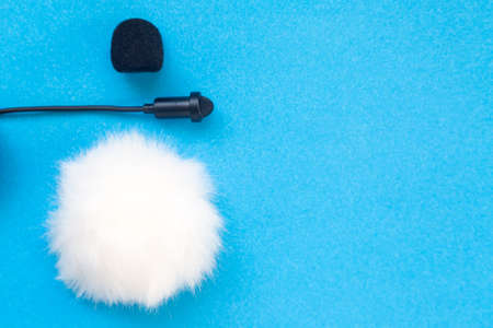 Lavalier small microphone and wind protection on blue background.の写真素材