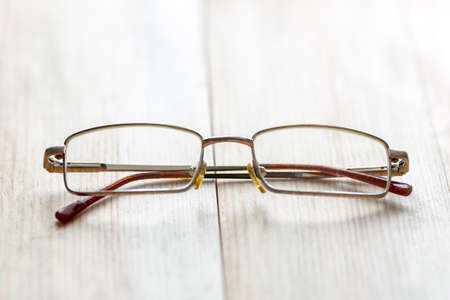 Glasses for eyes on a light wood background.の写真素材