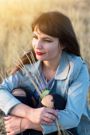 Portrait of young brunette woman with red lips on nature.の写真素材