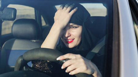A woman driving a car emotionally reacts others.の写真素材