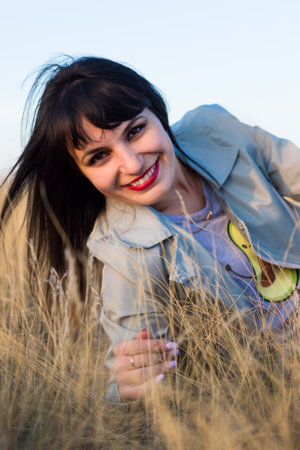 Brunette girl in nature. Close-up portrait.の写真素材