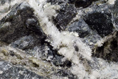 White fibers of asbestos mineral in stone, close-up