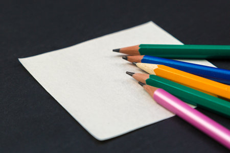 Colored pencils on paper for notes on a gray background.の写真素材