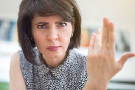 An outraged teacher in school classroom demands an answer from a student.の写真素材