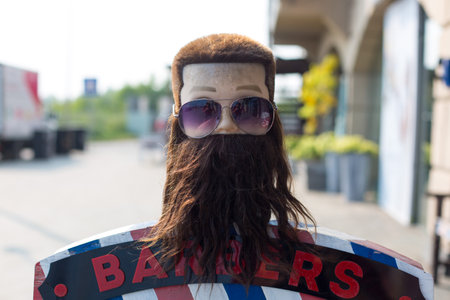 Irkutsk, Russia - July 28, 2021 Barber shop street advertisement, mannequin head with bushy beardのeditorial素材