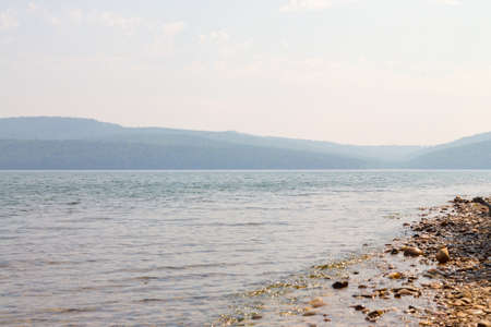 Beautiful view of quiet sea surface and mountains on a sunny summer day. Lake Baikal Russia.の写真素材