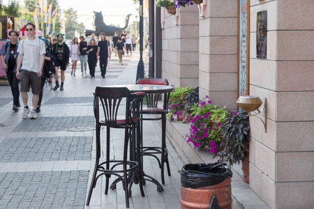 Irkutsk, Russia July 24, 2021 - An empty table and two high chairs on a city street. Editorial.のeditorial素材