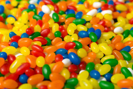 Bright colored small candy dragees yellow green red blue in the store.の写真素材