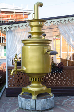 A large metal golden samovar on the street of the city, a photo zone for visitors.の写真素材