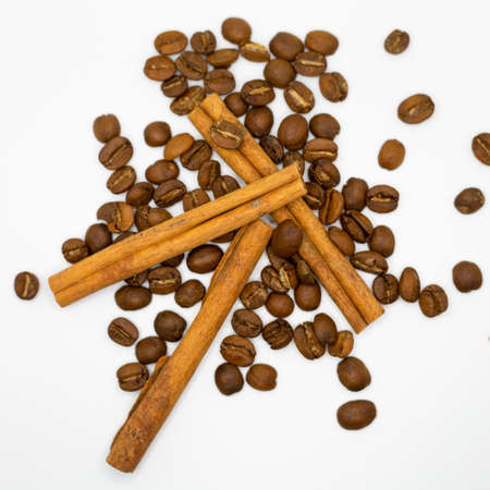 Cinnamon sticks and coffee beans on a white background, isolated.