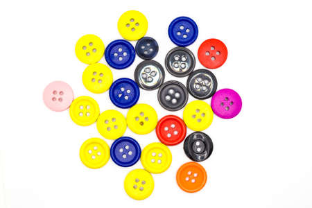 Lots of bright scattered colored buttons on a white background.