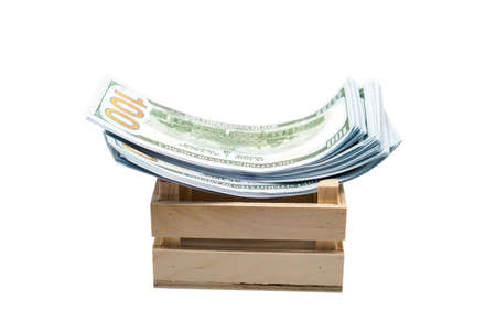 Paper money lies in small wooden box, isolated white background.の写真素材