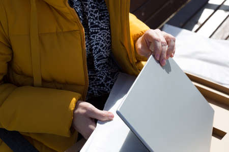 A woman inspects newly purchased laptop defects and defects.