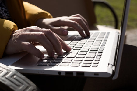 Freelancer hands computer keyboard typing message text.の写真素材