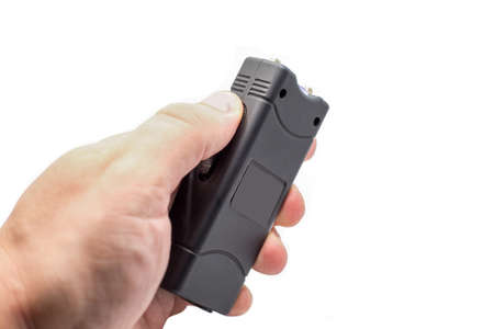 Taser a man's hand, close-up, isolated on a white background.