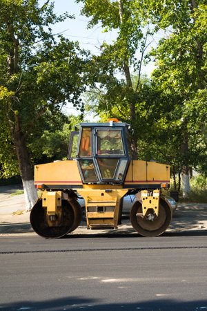 An asphalt paver is a skating rink for repairing roads on streets of the city standing idle during...