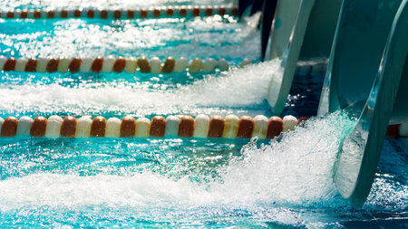 Sports pool with swimming lanes, sunlight.