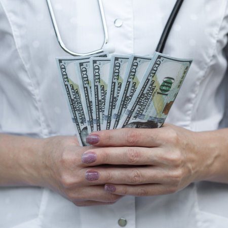 Medical worker with money in his hands, close-up.の写真素材