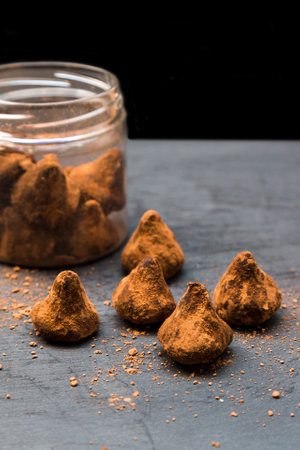 Portioned sugar scrub in the form of chocolate truffles on a black backgroundの写真素材