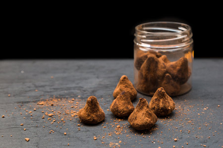 Portioned sugar scrub the form of chocolate truffles on a black backgroundの写真素材