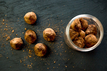 Portioned sugar scrub in the form of chocolate truffles on a black backgroundの写真素材