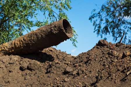 Replacement of the city water supply, old rusty pipes among heaps of earth.の写真素材