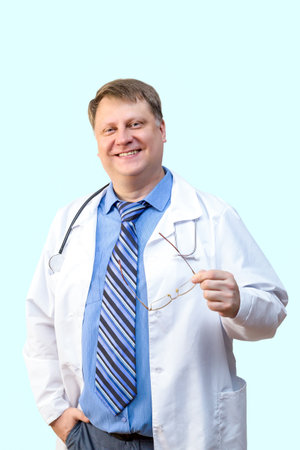 Male doctor in a blue shirt with a tie on a blue background.の写真素材