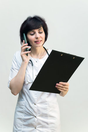 Nurse on the phone explaining the results of medical analysis.の写真素材