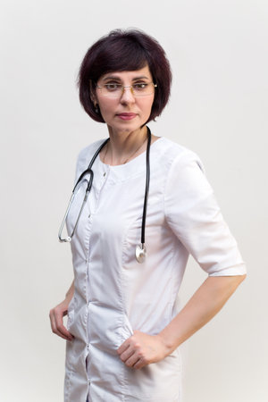 Woman medical worker in lab coat with glasses, white background.の写真素材