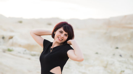 Beautiful sexy woman laughing posing desert photo session in Dubai.の写真素材