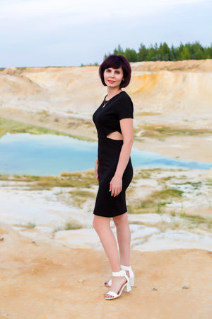 Beautiful brunette woman background of a lake in the desert.の写真素材