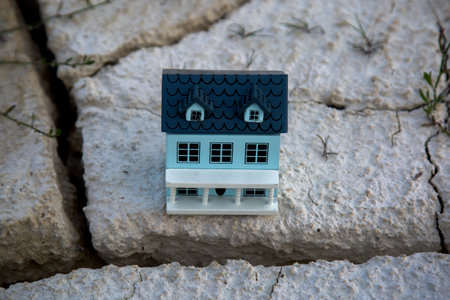 A small house edge of a precipice, the concept of an earthquake and landslides. Natural disaster, cataclysm.の写真素材