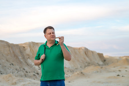 Male tourist kissing trained snake an excursion.の写真素材
