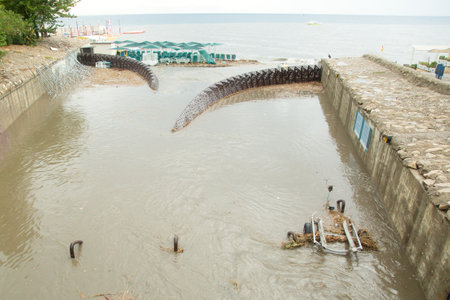 Garbage in city sewage, water channel with garbage flowing out city.の写真素材