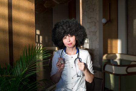 Multiethnic female doctor in a lab coat in the corridor of a clinic.の写真素材