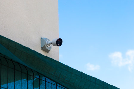 Outdoor surveillance camera mounted high on the wall.