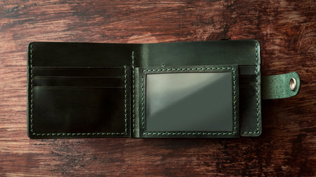 Men's wallet made black leather on dark stylish wood. Shooting for the catalog.