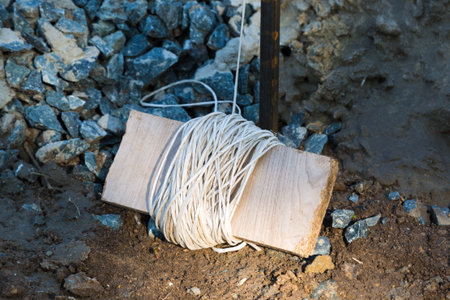 A roll of rope at a construction site for smooth laying of building material.