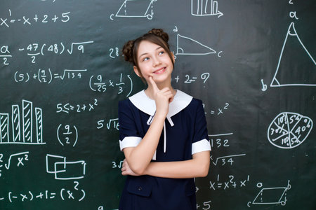 A teenage schoolgirl thought about the answer to the teacher's question.の写真素材